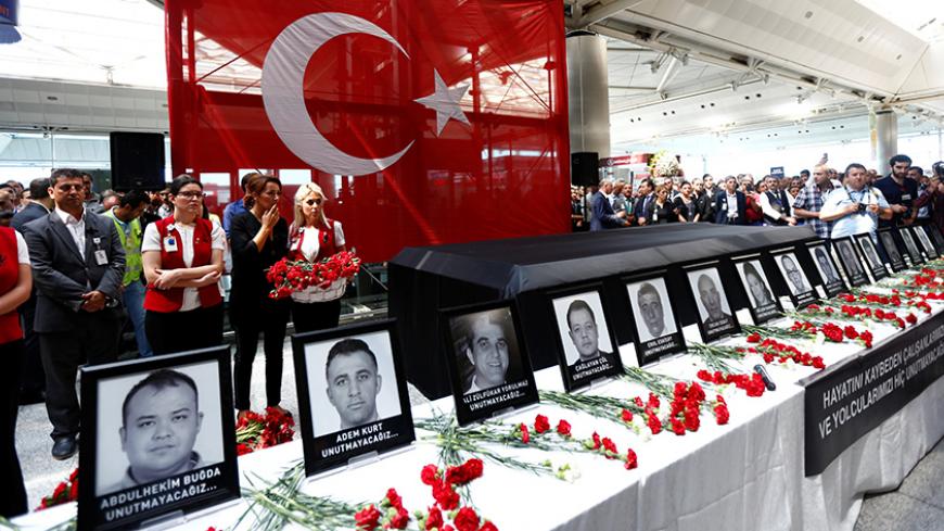 Airport employees attend a ceremony for their friends, who were killed in Tuesday's attack at the airport, at the international departure terminal of Ataturk airport in Istanbul, Turkey, June 30, 2016. REUTERS/Murad Sezer - RTX2J1PM