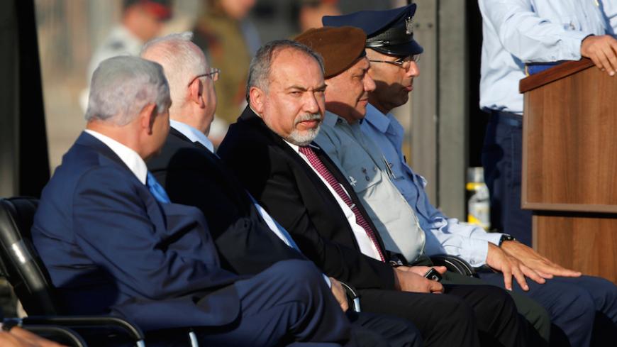 Israeli Defense Minister Avigdor Lieberman (C) attends a graduation ceremony for Israeli airforce pilots at the Hatzerim air base in southern Israel June 30, 2016. REUTERS/Amir Cohen - RTX2J3W0