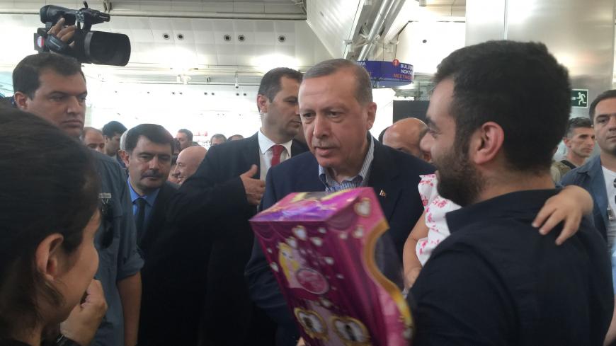 Turkish President Tayyip Erdogan chats with passengers at the international departure terminal during his visit to Ataturk airport in Istanbul, Turkey, July 2, 2016. REUTERS/Seda Sezer - RTX2JEBA