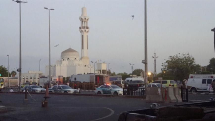 General view of security personnel in front of a mosque as police stage a second controlled explosion, after a suicide bomber was killed and two other people wounded in a blast near the U.S. consulate in Jeddah, Saudi Arabia, in this still frame taken from video July 4, 2016. REUTERS/REUTERS TV     TPX IMAGES OF THE DAY - RTX2JKFT
