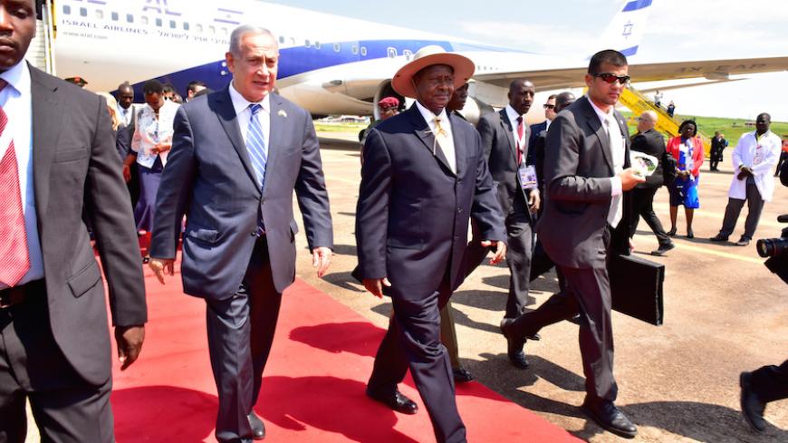 Israeli Prime Minister Benjamin Netanyahu (L) walks with Uganda's President Yoweri Museveni (R) after arriving to commemorate the 40th anniversary of Operation Entebbe at the Entebbe airport in Uganda, July 4, 2016. With them is Ugandan First Lady Janet Museveni (R). REUTERS/Presidential Press Unit/Handout via REUTERS ATTENTION EDITORS - THIS IMAGE WAS PROVIDED BY A THIRD PARTY. EDITORIAL USE ONLY. - RTX2JNYB