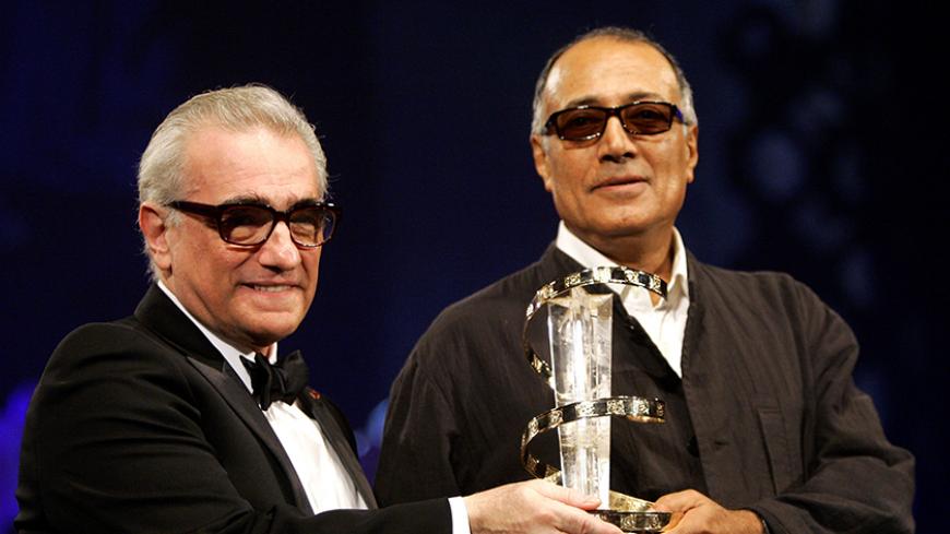 Iranian director Abbas Kiarostami (R) receives an award from U.S. director Martin Scorsese during the closing ceremony of the 5th Marrakesh International Film Festival in Marrakesh, Morocco, November 19, 2005. REUTERS/Andrea Comas/File Photo - RTX2JPDJ