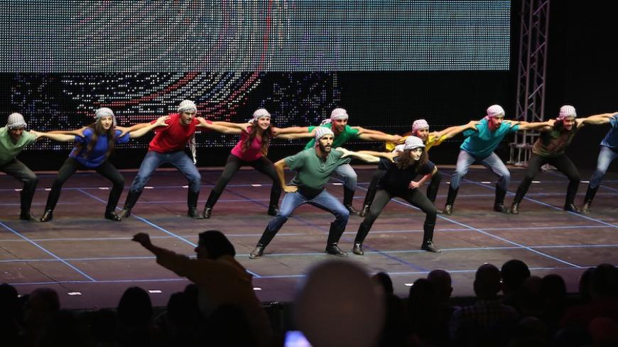 TO GO WITH AFP STORY BY HOSSAM EZZEDINE
Art students perform during the Palesitinian Dance and Song Festival against Discrimination late on August 4, 2015 in the West Bank city of Ramallah. AFP PHOTO / ABBAS MOMANI        (Photo credit should read ABBAS MOMANI/AFP/Getty Images)