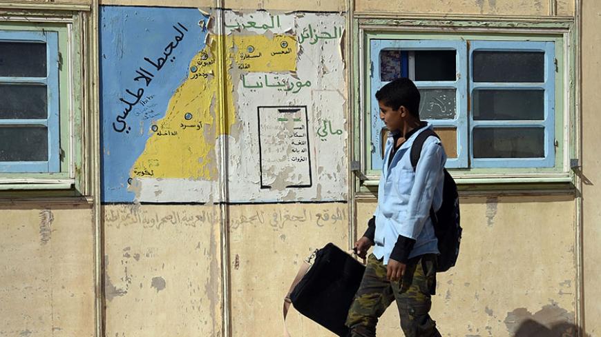 A student walks past a map at a school in the Smara refugee camp in Algeria's Tindouf province on February 25, 2016.
The Western Sahara is a territory bordered by Morocco and Algeria and disputed by Spain and Morocco who both claiming sovereignty. / AFP / Farouk Batiche        (Photo credit should read FAROUK BATICHE/AFP/Getty Images)