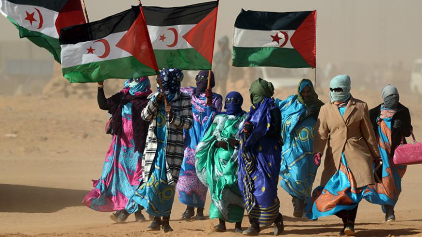Sahrawi women hold Polisario Front's flags during a ceremony to mark 40 years after the Front proclaimed the Sahrawi Arab Democratic Republic (SADR) in the disputed territory of Western Sahara on February 27, 2016 at the Sahrawi refugee camp of Dakhla which lies 170 km to the southeast of the Algerian city of Tindouf. 
SADR was declared in 1976 by the Polisario Front -- a rebel movement that wants independence for Western Sahara -- which fought a guerrilla war against Rabat's forces before a ceasefire in 19