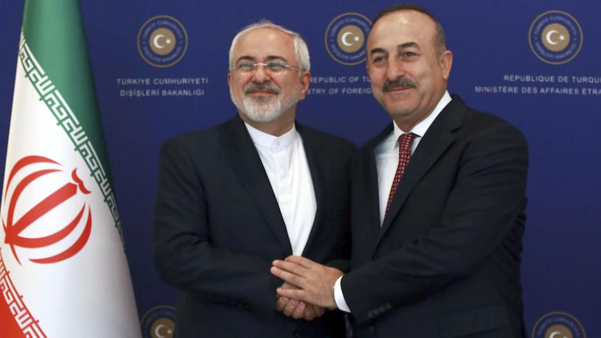 Turkish Foreign Minister Mevlut Cavusoglu (R) shakes hands with his Iranian counterpart Mohammad Javad Zarif (L) during a meeting at the Foreign Ministry in Ankara on August 12, 2016.  / AFP / ADEM ALTAN        (Photo credit should read ADEM ALTAN/AFP/Getty Images)