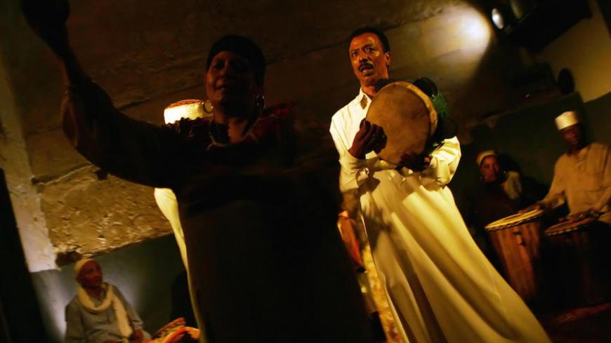 Cairo, EGYPT:  TO GO WITH STORY BY JOELLE BASSOUL Zar musicians and healers perform their ritual in Cairo late 21 June 2006. The Zar trans religious ceremony, which uses drumming and dancing to cure an illness thought to be caused by a demon, is most prominent in southern Egypt and is practiced further south into the Sudan, though in fact it may be performed anywhere in Egypt. The ritual, a type of a healing cult, is prohibited by Islam as a pagan practice but it continues to be part of Egypt's popular cult