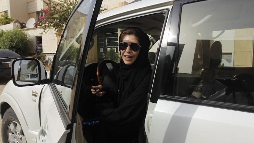Female driver Azza Al Shmasani alights from her car after driving in defiance of the ban in Riyadh June 22, 2011. Saudi Arabia has no formal ban on women driving. But as citizens must use only Saudi-issued licences in the country, and as these are issued only to men, women drivers are anathema. An outcry at the segregation, which contributes to the general cloistering of Saudi women, has been fuelled by social media interest in two would-be female motorists arrested in May.REUTERS/Fahad Shadeed (SAUDI ARABI