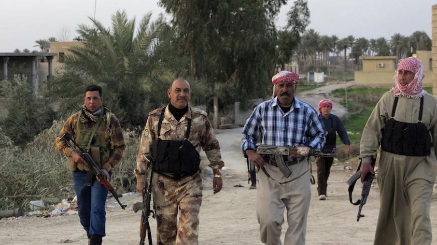 Iraqi Sunni Muslim tribesmen walk with their weapons during a patrol in Anbar province in this March 3, 2014 picture. Government forces are fighting rebellious Sunni tribes and al-Qaeda splinter group, Islamic State of Iraq and the Levant (ISIL), in western Anbar province.  Picture taken March 3, 2014.  REUTERS/Ali al-Mashhadani (IRAQ - Tags: CIVIL UNREST POLITICS) - RTR3G33Q