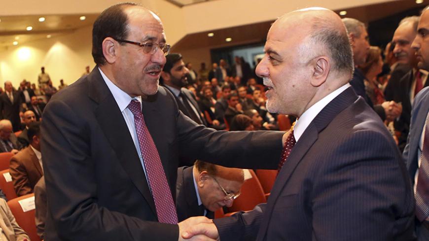 Iraq's Vice President Nouri al-Maliki (L) and new Prime Minister Haider al-Abadi shake hands during the session to approve the new government in Baghdad, September 8, 2014.Iraq's parliament approved a new government headed by Haider al-Abadi as prime minister on Monday night, in a bid to rescue Iraq from collapse, with sectarianism and Arab-Kurdish tensions on the rise. REUTERS/Hadi Mizban/Pool (IRAQ - Tags: POLITICS) - RTR45G35