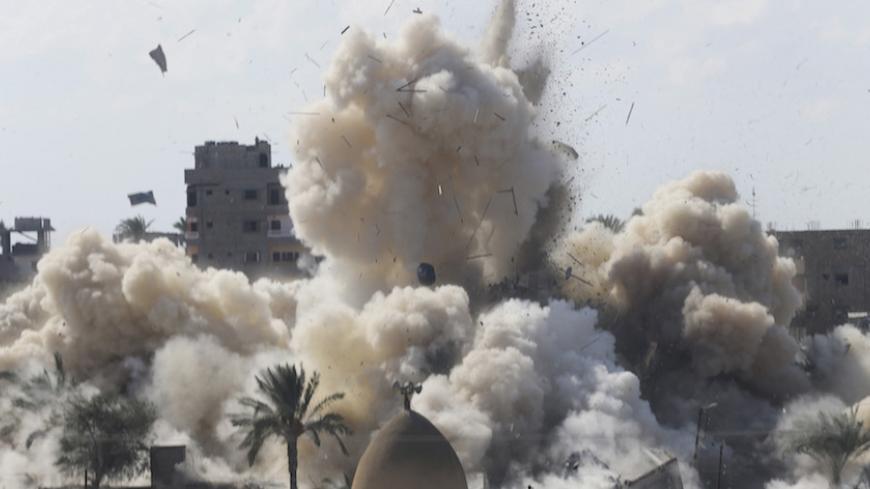 Smoke rises after a house was blown up during a military operation by Egyptian security forces in the Egyptian city of Rafah, near the border with southern Gaza Strip October 29, 2014. At least 33 Egyptian security personnel were killed on Friday in the Sinai Peninsula bordering Israel and Gaza, in an attack on a checkpoint that bore the marks of assaults claimed by Egypt's most active militant group Ansar Bayt al-Maqdis. Egypt's President Abdel Fattah al-Sisi said on Saturday the military would respond wit