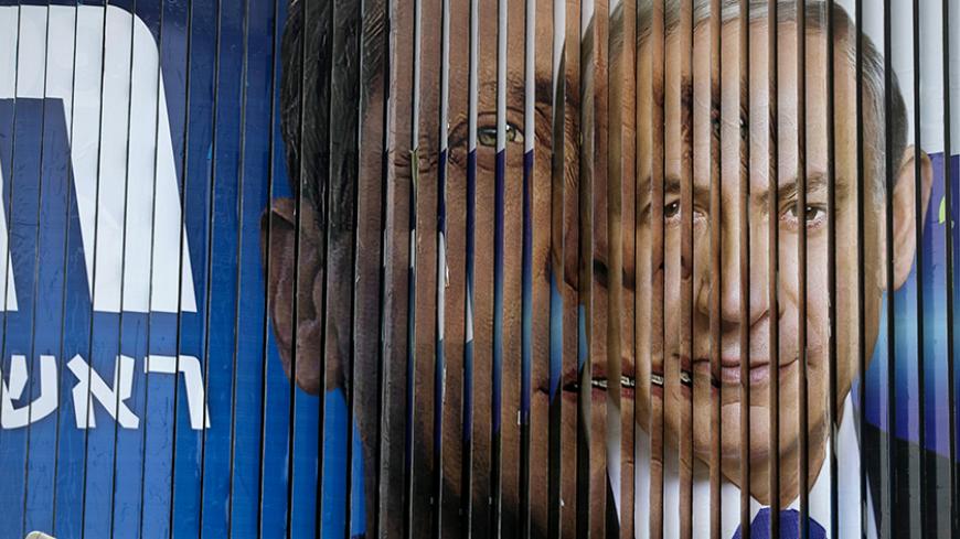 Israel's Prime Minister Benjamin Netanyahu (R) and Isaac Herzog, Co-leader of the centre-left Zionist Union, are pictured together as campaign billboards rotate in Tel Aviv, March 9, 2015. Israelis will vote in a parliamentary election on March 17, choosing among party lists of candidates to serve in the 120-seat Knesset. Currently, polls show Netanyahu's Likud party and the centre-left Zionist Union opposition running neck-and-neck, with each predicted to win around 24 seats in the Knesset. 
REUTERS/Baz Ra