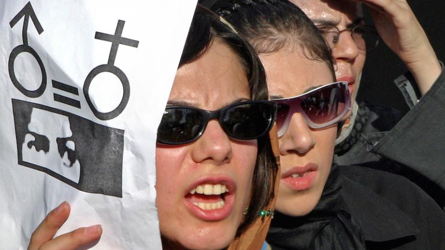 Iranian women take part in a protest in front of the Tehran University in Tehran June 12, 2005. About 300 women took part in the protest against gender discrimination in the Islamic republic of Iran. REUTERS/Raheb Homavandi  PJH - RTRE6DE