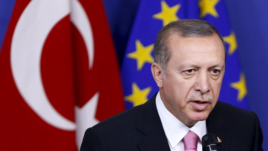 Turkey's President Tayyip Erdogan talks to the media before a meeting with European Commission President Jean-Claude Juncker (not pictured) at the EU Commission headquarters in Brussels, Belgium, October 5, 2015. Erdogan mocked European Union overtures for help with its migration crisis during a long-awaited visit to Brussels on Monday that in the end was partly overshadowed by Russia's violation of Turkish airspace near Syria. REUTERS/Francois Lenoir  - RTS34D3
