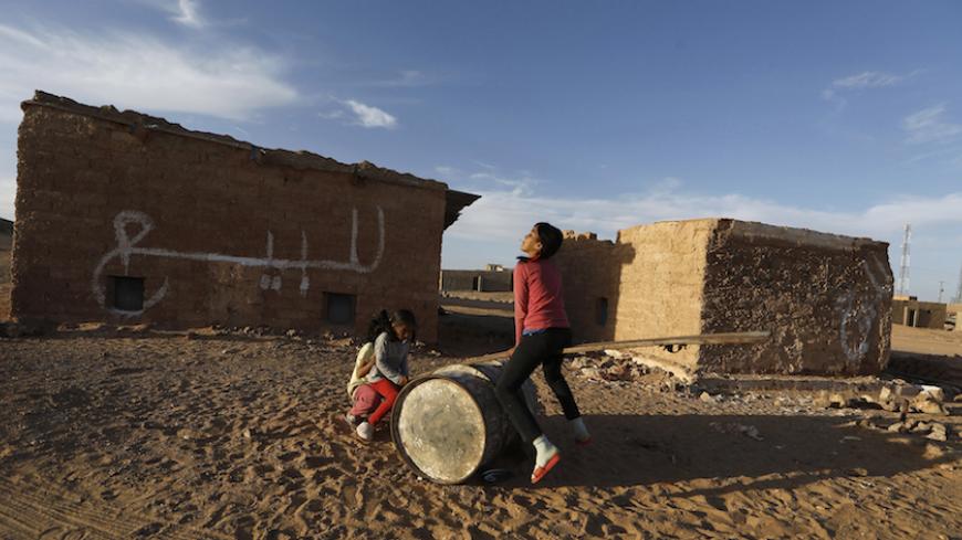 Indigenous Sahrawi girls play on an improvised see-saw at a refugee camp of Boudjdour in Tindouf, southern Algeria March 3, 2016. The UN Secretary-General Ban Ki-moon is scheduled to visit the Sahrawi refugees in south-west Algeria's Tindouf region. REUTERS/Zohra Bensemra      TPX IMAGES OF THE DAY      - RTS96QU