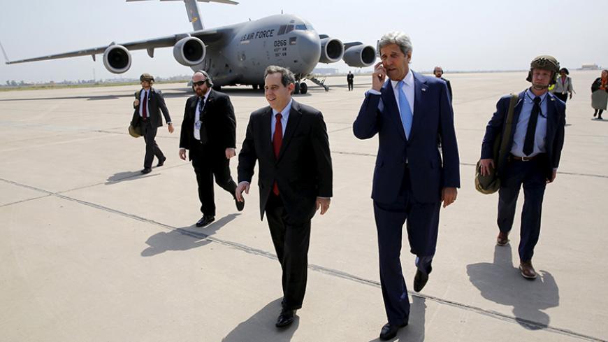 U.S. Ambassador to Iraq Stuart Jones (center L) walks with Secretary of State John Kerry (center R) as he arrives via military transport at Baghdad International Airport in Baghdad April 8, 2016. REUTERS/Jonathan Ernst      TPX IMAGES OF THE DAY      - RTSE4QI