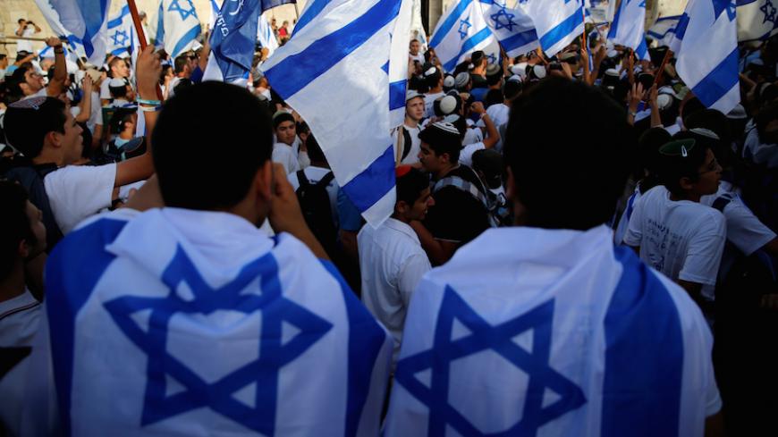Israelis carry flags during a march marking Jerusalem Day, the anniversary of Israel's capture of East Jerusalem during the 1967 Middle East war, just outside Damascus Gate of Jerusalem's Old City June 5, 2016. REUTERS/Ammar Awad - RTSG3ZM