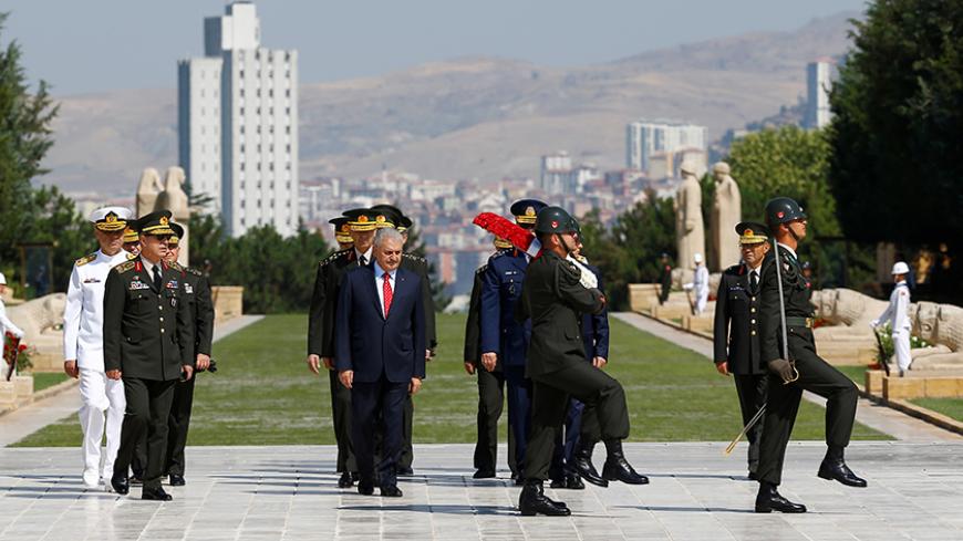 Turkey's Prime Minister Binali Yildirim, flanked by Chief of Staff General Hulusi Akar (2nd L)  and the country's top generals, attends a wreath-laying ceremony in Anitkabir, the mausoleum of modern Turkey's founder Mustafa Kemal Ataturk, ahead of a High Military Council meeting in Ankara, Turkey, July 28, 2016. REUTERS/Umit Bektas - RTSK1HU