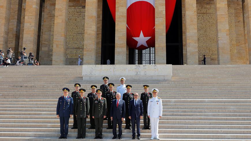 Turkey's Prime Minister Binali Yildirim (3rd R), Chief of Staff General Hulusi Akar (3rd L), Defense Minister Fikri Isik (2nd R) and the country's top generals pose in Anitkabir, the mausoleum of modern Turkey's founder Mustafa Kemal Ataturk, after a wreath-laying ceremony ahead of a High Military Council meeting in Ankara, Turkey, July 28, 2016. REUTERS/Umit Bektas - RTSK1K7