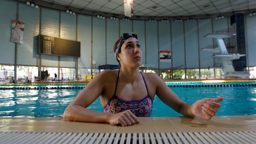Syrian swimmer Baean Jouma trains for the 2016 Rio Olympics with posters of Syrian president Bashar al-Assad hung in the background, in Damascus, Syria July 16, 2016. REUTERS/Omar Sanadiki         SEARCH "SYRIANS OLYMPICS" FOR THIS STORY. SEARCH "THE WIDER IMAGE" FOR ALL STORIES - RTSKZVR