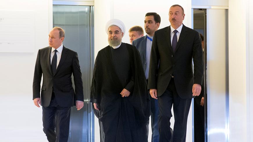 Russian President Vladimir Putin, Iranian President Hassan Rouhani and Azeri President Ilham Aliyev arrive for their meeting in Baku, Azerbaijan, August 8, 2016.  REUTERS/Alexander Zemlianichenko/Pool - RTSLUSE