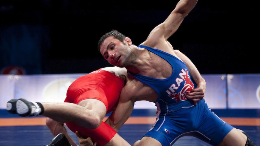 Sep 12, 2015; Las Vegas, NV, USA; Hassan Sabzali Rahimi of Iran (blue) competes against Vladimer Khinchegashvili of Georgia (red) in the mens 57kg freestyle on the final day of the World Wrestling Championships at The Orleans Arena. Mandatory Credit: Stephen R. Sylvanie-USA TODAY Sports - RTSTUJ