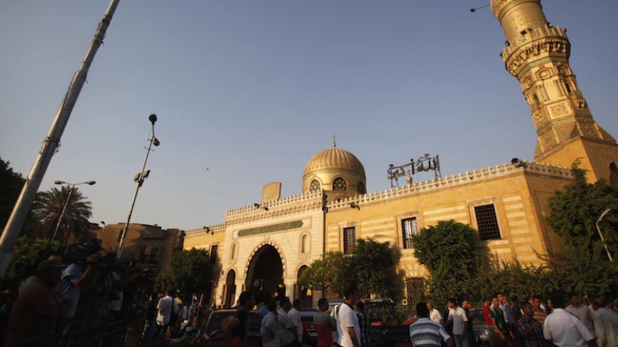Egyptians stand outside El Sayeda Nafisa Mosque after funeral prayers for Shi'ite victims, who were killed in sectarian violence, in Cairo, June 24, 2013. Egypt's president, accused of fuelling sectarian hatred, promised swift justice on Monday for a deadly attack on minority Shi'ites as he tried to quell broader factional fighting to avoid a threatened military intervention. REUTERS/Amr Abdallah Dalsh  (EGYPT - Tags: POLITICS CIVIL UNREST RELIGION) - RTX10ZDZ