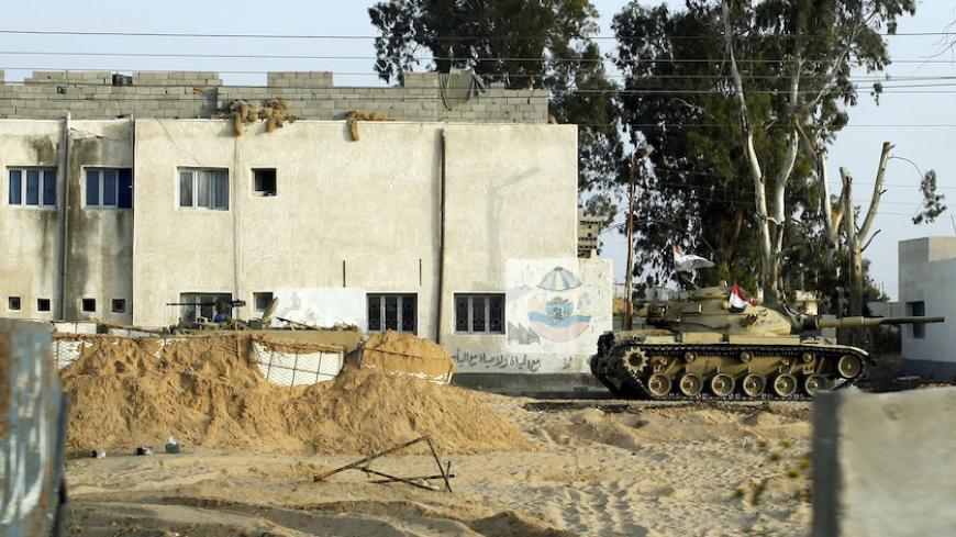 An Egyptian army tank is seen stationed outside a school taken over by soldiers in the Sinai Peninsula between the northern Sinai cities of Al-Arish and Sheikh Zuwayed, May 25, 2015. Authorities in the Sinai Peninsula are battling insurgents who support Islamic State, the militant group that has seized parts of Iraq, Syria and Libya. The Sinai conflict, which has has displaced hundreds of Egyptians, is the biggest security challenge for President Abdel Fattah al-Sisi, who has promised to deliver stability a
