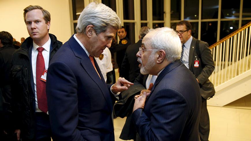 U.S. Secretary of State John Kerry talks with Iranian Foreign Minister Javad Zarif after the International Atomic Energy Agency (IAEA) verified that Iran has met all conditions under the nuclear deal, in Vienna January 16, 2016. REUTERS/Kevin Lamarque - RTX22P9I