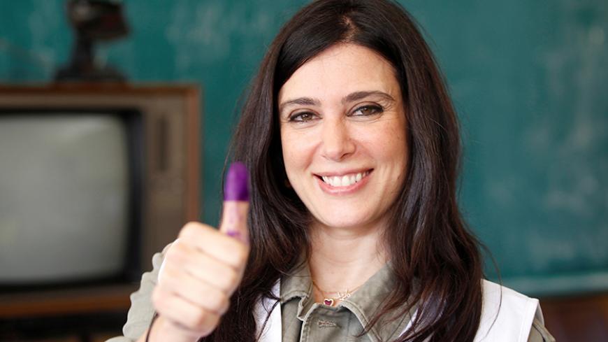 Lebanese actress and director Nadine Labaki, a Beirut Madinati candidate, shows her ink-stained finger after casting her ballot at a polling station during Beirut's municipal elections, Lebanon, May 8, 2016. REUTERS/Mohamed Azakir - RTX2DC64