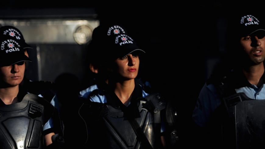 Turkish riot police stand guard as Kurdish women (unseen) sit during a protest in downtown Istanbul, on August 29, 2011. The group of Kurdish women gathered to protest Turkish military air strikes against Kurdish separatists in northern Iraq. Meanwhile, Turkish jets bombed bases in northern Iraq used by the separatist Kurdistan Workers' Party (PKK) in a fresh campaign which has killed as many as 160 rebels since last week, the military said on August 29. AFP PHOTO / BULENT KILIC (Photo credit should read BU