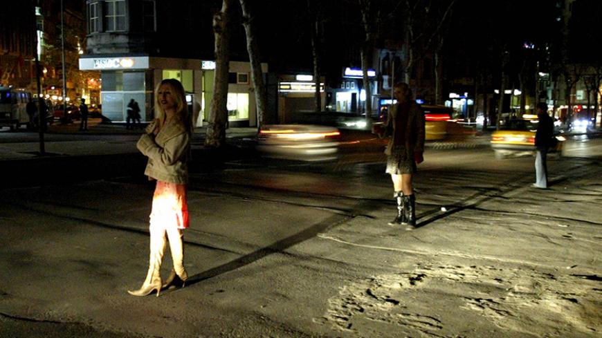ISTANBUL, TURKEY:  Two unidentified transsexual prostitutes stand near the main road waiting for customer in central Istanbul, in Taksim Square, 12 December 2003. AFP PHOTO/ Mustafa Ozer  (Photo credit should read MUSTAFA OZER/AFP/Getty Images)