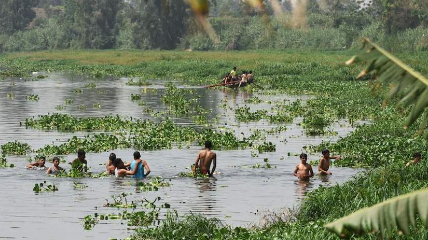 Egyptians take a dip in one of the branches of the Nile in the Menufiya district, north of the capital Cairo, on May 2, 2016, as they celebrate Sham al-Nessim, a Pharaonic feast that marks the start of spring.

 / AFP / MOHAMED EL-SHAHED        (Photo credit should read MOHAMED EL-SHAHED/AFP/Getty Images)