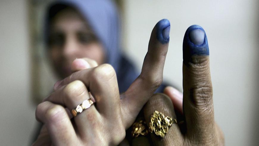 GAZA CITY, GAZA STRIP - JANUARY 25:  Palestinian women show their inked fingers after voting in the Palestinian legislative election at a UN school which is being used as a polling station, January 25, 2006, in Gaza City, Gaza Strip. The newly elected Palestinian Legislative Council (PLC) will be expanded, and half of the seats will be allotted by proportional representation of all parties that gather more than two percent of the vote. (Photo by Abid Katib/Getty Images)