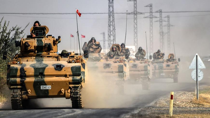 TOPSHOT - This picture taken around 5 kilometres west from the Turkish Syrian border city of Karkamis in the southern region of Gaziantep, on August 25, 2016 shows Turkish Army tanks driving to the Syrian Turkish border town of Jarabulus.
Turkey's army backed by international coalition air strikes launched an operation involving fighter jets and elite ground troops to drive Islamic State jihadists out of a key Syrian border town. The air and ground operation, the most ambitious launched by Turkey in the Syr