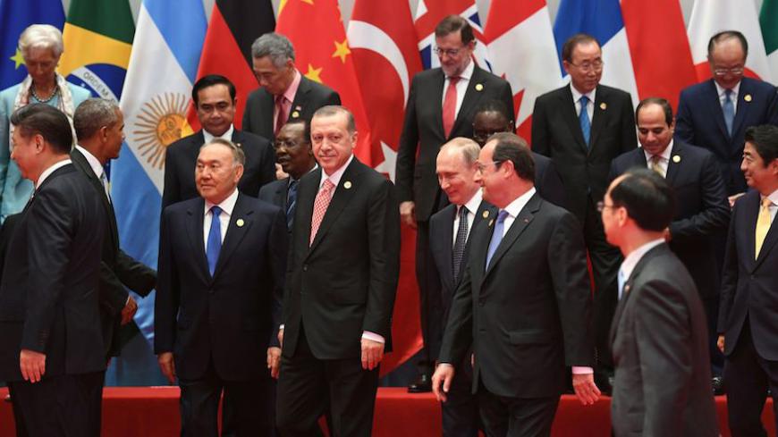 fRONT l-r: China's President Xi Jinping, US President Barack Obama, Kazakhstan's President Nursultan Nazarbayev, Turkey's President Recep Tayyip Erdogan, Russia's President Vladimir Putin, French President Francois Hollande, and Japan's Prime Minister Shinzo Abe (far R) walks following the G20 leaders' family photo in Hangzhou on September 4, 2016.

World leaders are gathering in Hangzhou for the 11th G20 Leaders Summit from September 4 to 5. / AFP / Greg BAKER        (Photo credit should read GREG BAKER/AF