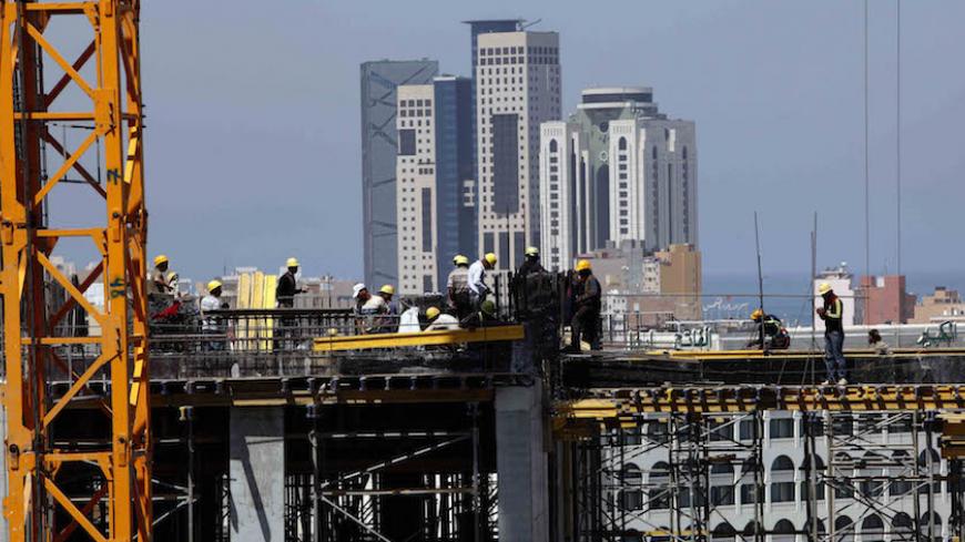 Egyptian and Syrian construction labourers work at the site of Al Ghazala InterContinental Hotel building project in Tripoli May 11, 2010. Libya is using the cash pile it built up from exporting oil and gas to pay for a frenzy of economic development. Foreign businessmen are rushing into Libya to win a share of a boom undimmed by the slowdown affecting the rest of the world. Picture taken May 11, 2010. To match Feature FRONTIERS/LIBYA  REUTERS/Ismail Zitouny (LIBYA - Tags: BUSINESS CONSTRUCTION ENERGY) - RT