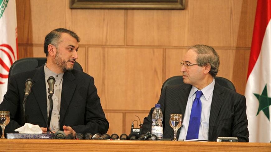 Iran's Deputy Foreign Minister Hossein Amir-Abdollahian (L) looks upon Syria's Deputy Foreign Minister Faisal Mekdad during a joint press conference in Damascus, Syria September 3, 2015. REUTERS/Omar Sanadiki - RTS6SCV