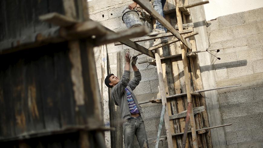 Palestinian boy Abed al-Kareem Yassin, 16, works at a construction site of a house in Gaza City March 21, 2016.  Yassin, whose father is unemployed, earns 40 Shekels ($10.3) per working day, and he and his two brothers are the main breadwinners of his family. The boy, who quit school, hopes to be a mechanic. REUTERS/Mohammed Salem   SEARCH "SALEM LABOUR" FOR THIS STORY. SEARCH "THE WIDER IMAGE" FOR ALL STORIES   - RTSCT7H