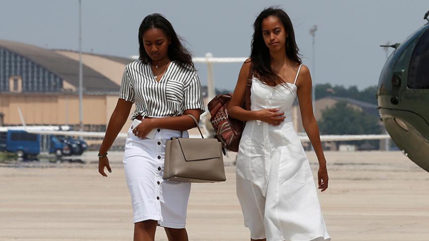 U.S. President Barack Obama's daughters Sasha (L) and Malia arrive with their parents to board Air Force One for travel to Massachusetts for their annual vacation at Martha's Vineyard, from Joint Base Andrews, Maryland, U.S. August 6, 2016. REUTERS/Jonathan Ernst - RTSLFBL