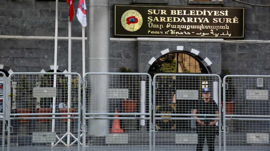A riot police officer stands guard in front of Sur municipality office, following the removal of the local mayor from office after he was deemed to support Kurdish militants, in Diyarbakir, Turkey, September 11, 2016. REUTERS/Sertac Kayar - RTSN757