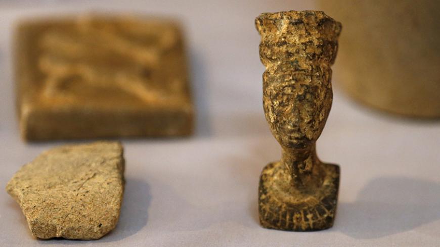 Recovered artifacts are seen at the National Museum of Iraq in Baghdad July 15, 2015. The U.S. handed back to Iraq on Wednesday antiquities it said it had seized in a raid on Islamic State fighters in Syria, saying the haul was proof the militants were funding their war by smuggling ancient treasures. The Iraqi relics were captured by U.S. special forces in an operation in May against an Islamic State commander known as Abu Sayyaf. They included ancient cylindrical stamps, pottery, metallic bracelets and ot