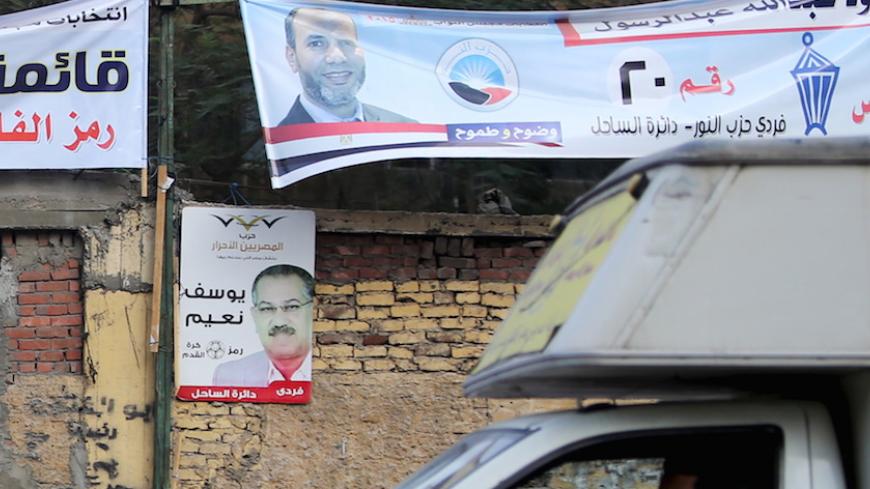 Electoral banners for the Salafist political party "al-Nour" (top) are seen in Shubra area in Cairo during the second day of the second round of Egypt's parliamentary elections, Egypt, November 23, 2015. REUTERS/Mohamed Abd El Ghany - RTX1VH3O