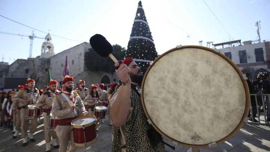 A Palestinian marching band parades during a Christmas procession at Manger Square in the West Bank town of Bethlehem December 24, 2015. REUTERS/Mohamad Torokman - RTX1ZYV3