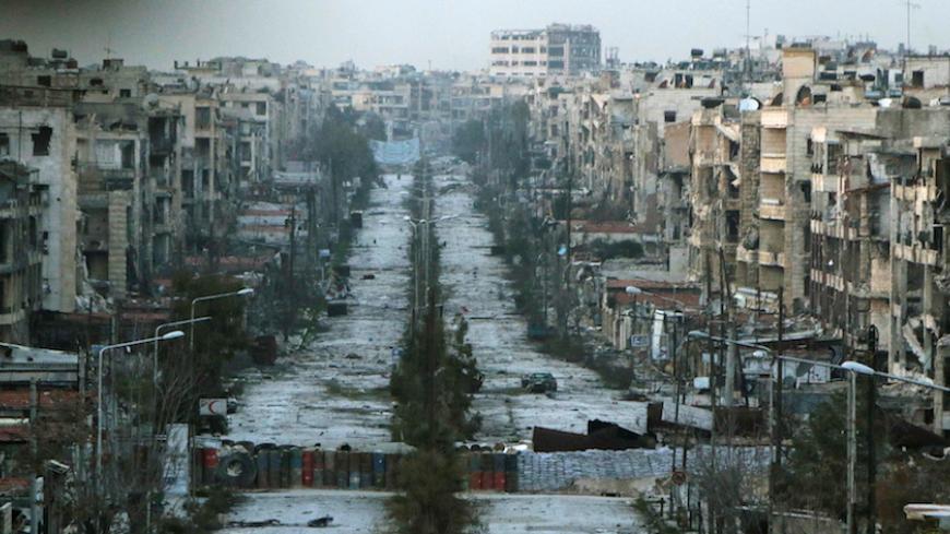 A general view shows a damaged street with sandbags used as barriers in Aleppo's Saif al-Dawla district, Syria March 6, 2015. REUTERS/Hosam Katan/File Photo - RTX2CYZW