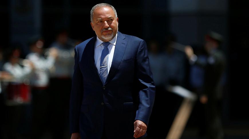 Israel's new Defence Minister, Avigdor Lieberman, head of far-right Yisrael Beitenu party, reviews an honour guard during a welcoming ceremony at the Defence Ministry in Tel Aviv, Israel May 31, 2016. REUTERS/Ronen Zvulun - RTX2EXRI