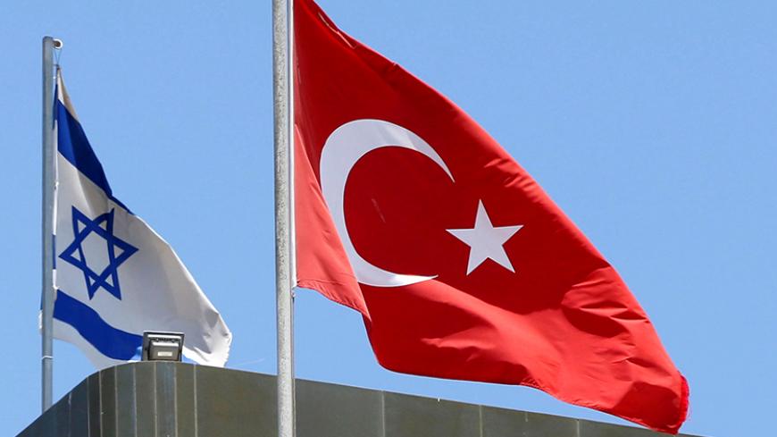 A Turkish flag flutters atop the Turkish embassy as an Israeli flag is seen nearby, in Tel Aviv, Israel June 26, 2016.  REUTERS/Baz Ratner/File Photo - RTX2LGJ5
