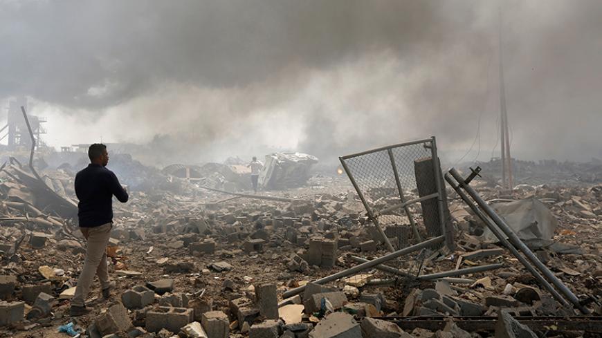 A man walks at a destroyed building at the site of a blast caused by a fire at a weapons storage in eastern Baghdad, Iraq, September 2, 2016. REUTERS/Ahmed Saad - RTX2NV19