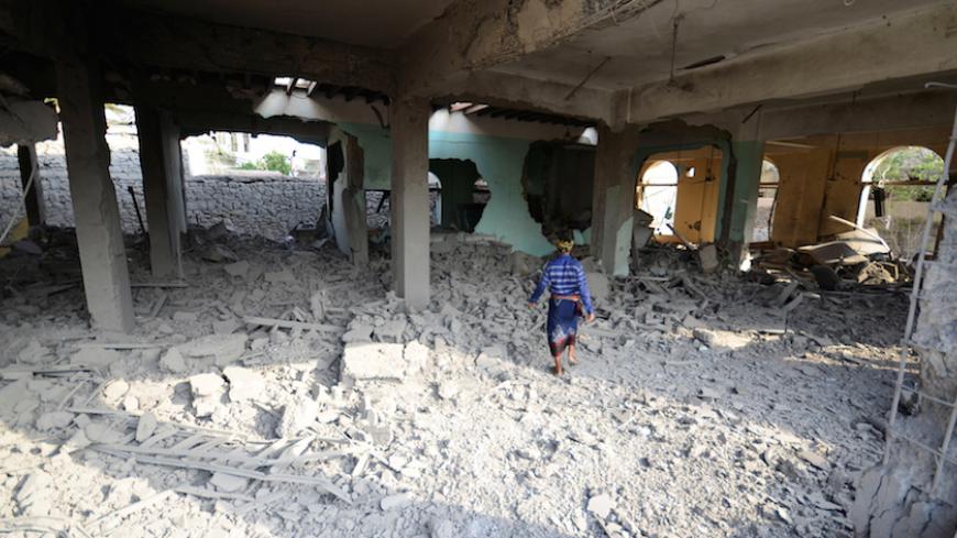 A man walks inside a building destroyed by a Saudi-led air strike in the Red Sea port city of Houdieda, Yemen, September 5, 2016. REUTERS/Abduljabbar Zeyad - RTX2O5W7