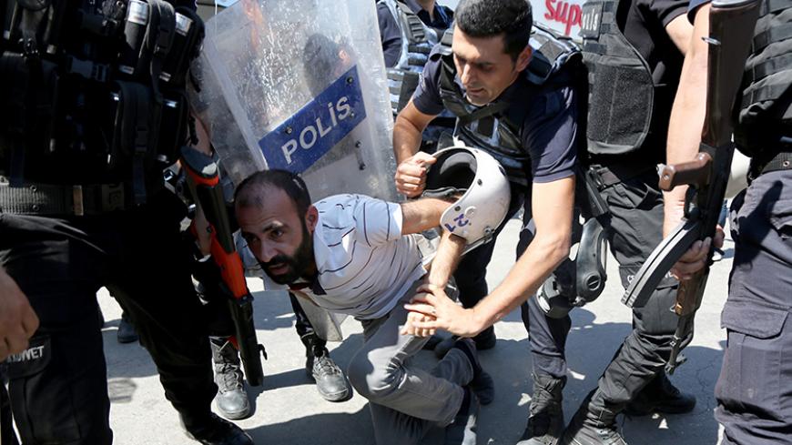 Riot police detain a demonstrator during a protest against the suspension of teachers from classrooms over alleged links with Kurdish militants, in the southeastern city of Diyarbakir, Turkey, September 9, 2016. REUTERS/Sertac Kayar - RTX2OUAT